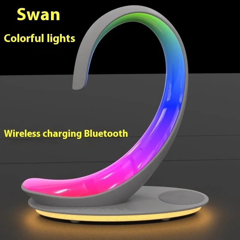 White swan decorative desk lamp with colourful RGB lighting, Bluetooth speaker, and wireless charging pad