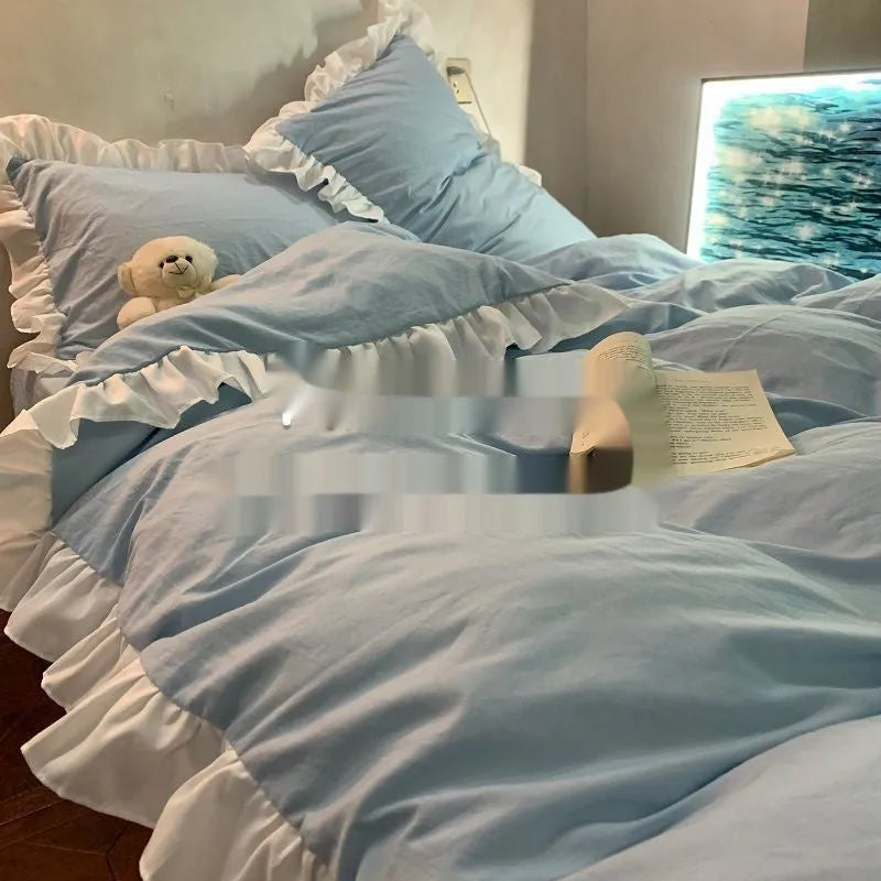 Washed cotton linen four-piece bedding set in a solid colour, shown on a bed with quilt cover and matching pillowcases.
