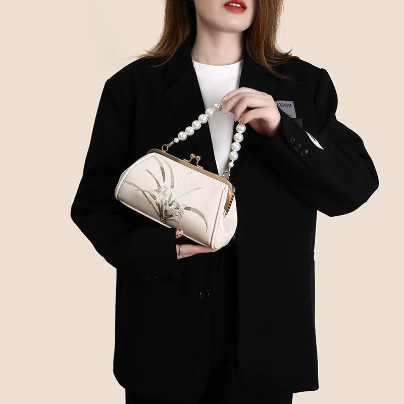 Beige women's embroidered shoulder bag in soft PU leather with shell-shaped design
