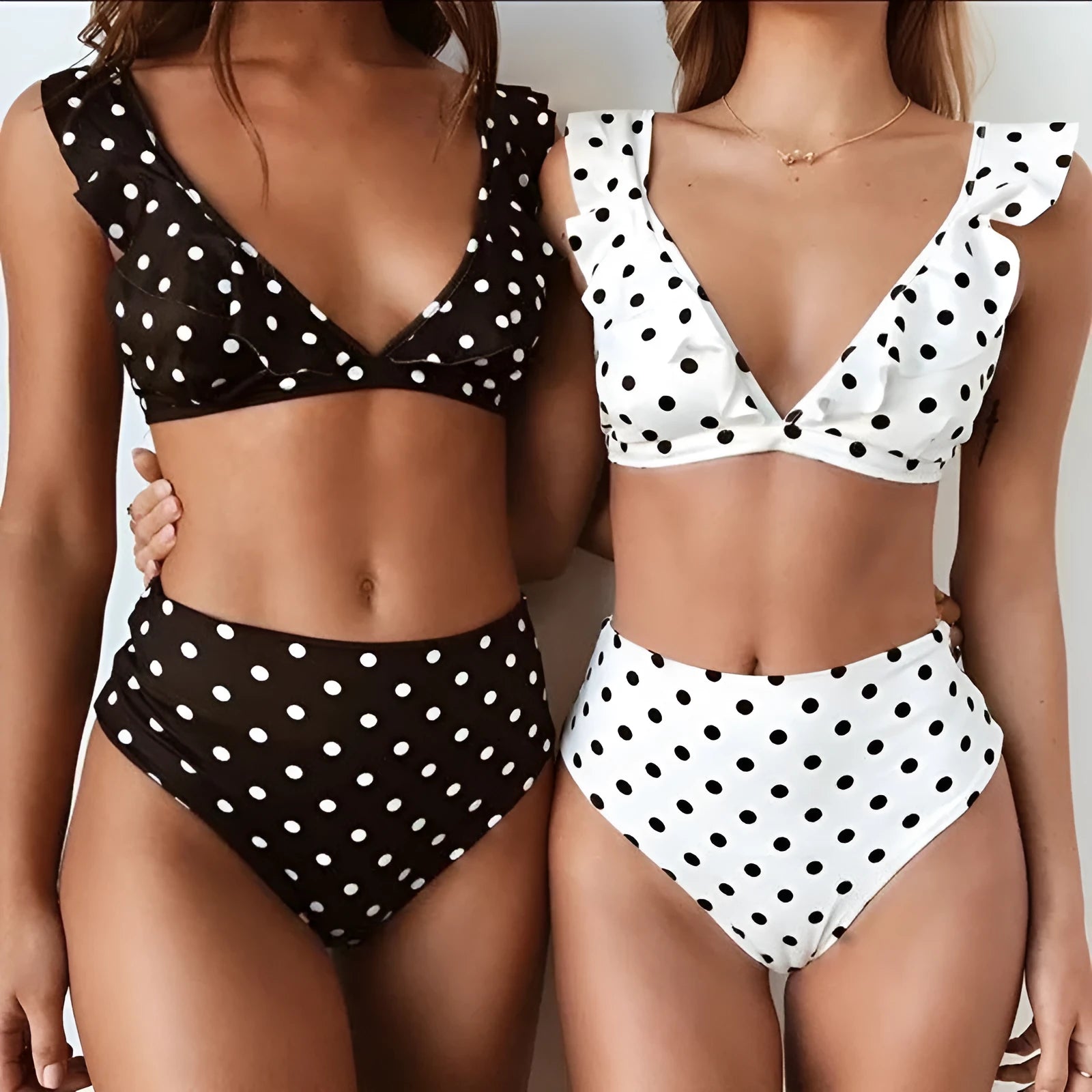 Black and white polka dot print swimsuit with ruffled detailing and deep V-neck
