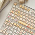 Rabbit Bear Restaurant themed PBT keycap set with EOA height profile, showing 140 colourful keycaps with sublimated designs.