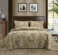 Blue American floral pattern cotton quilted bedspread set of three pieces laid on a bed.
