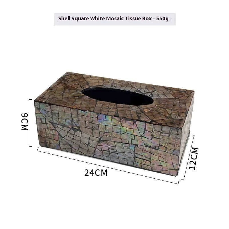 A black square natural shell storage box with a removable white internal organiser on a wooden table.