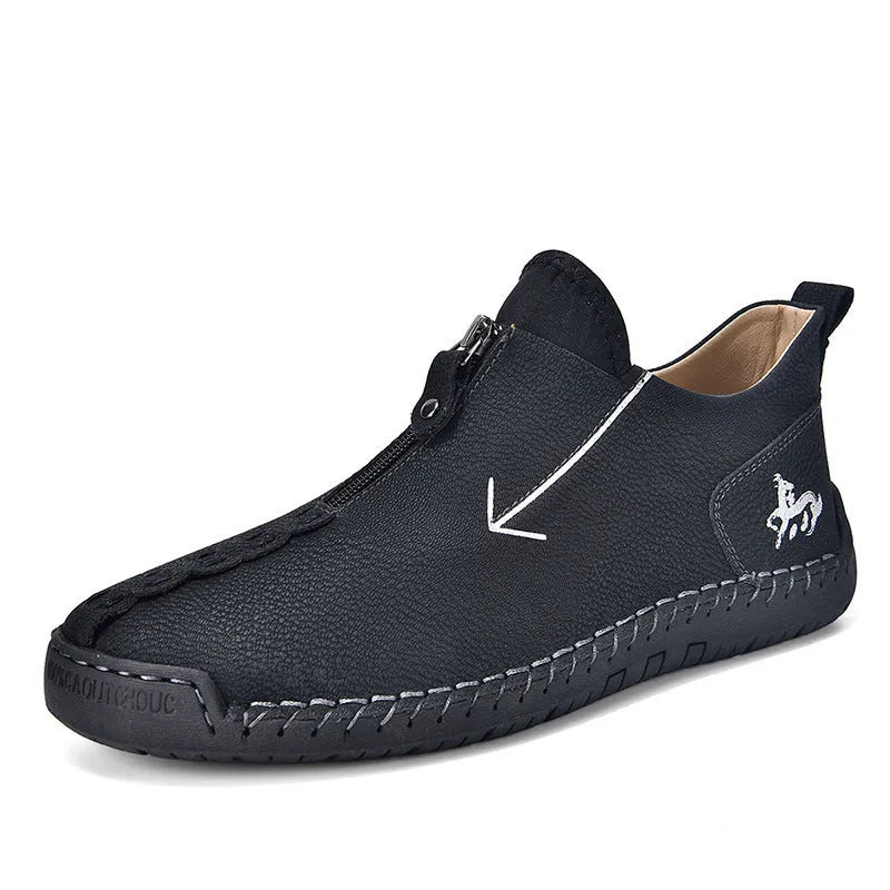 Men's black leather martin boots with a front metal zipper and round toe on a rubber sole.