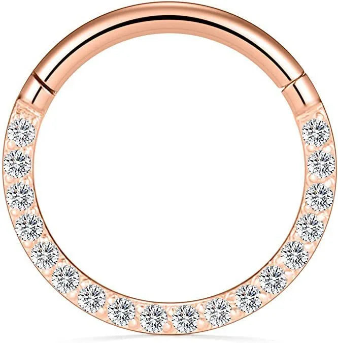 A round stainless steel seamless nose ring on a grey background, shown in a gold plated finish.
