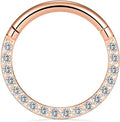 A round stainless steel seamless nose ring on a grey background, shown in a gold plated finish.