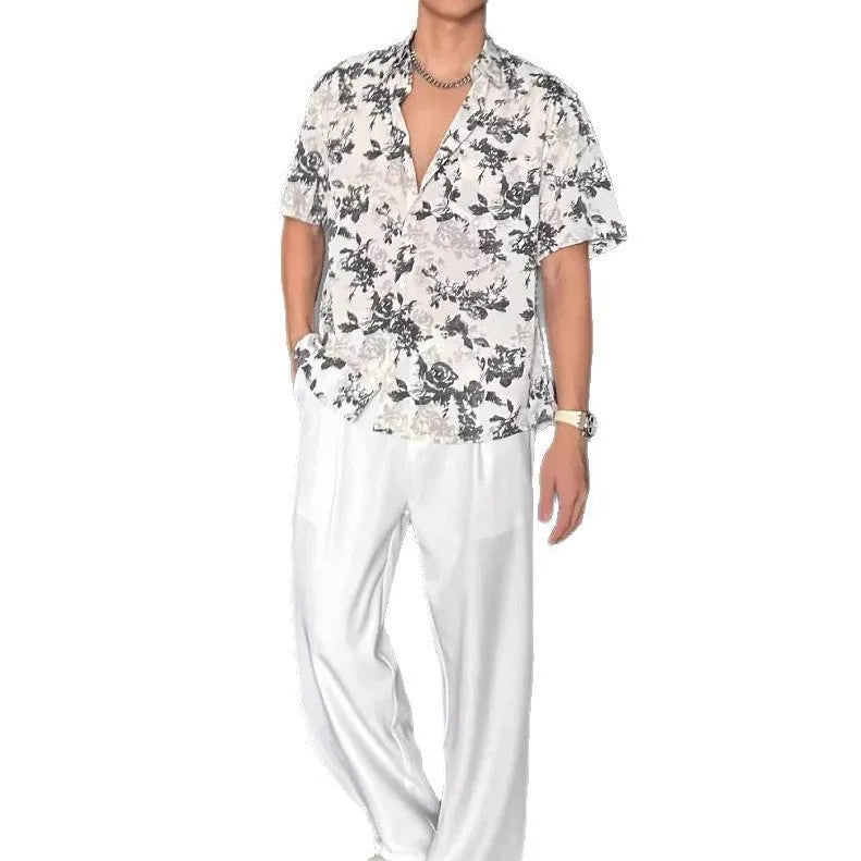 Loose black and white floral print short sleeve casual shirt for women on a hanger