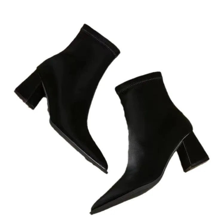 Women's khaki pointed toe Martin boots with a wedge heel on a rubber sole.
