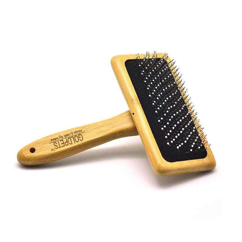 Pet grooming bamboo wood air cushion needle comb in original bamboo colour with steel pins, shown on a table