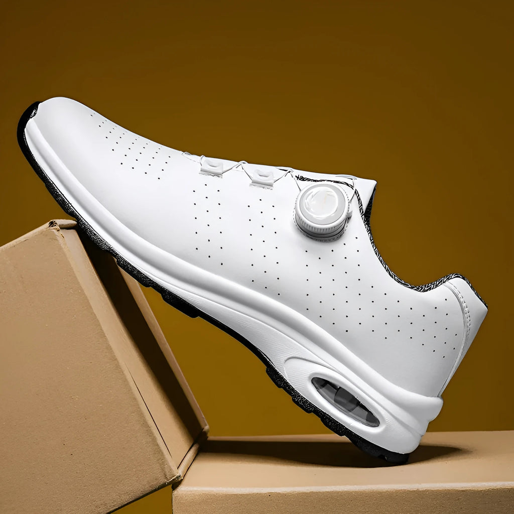 Pair of black low-top mesh tennis shoes with cross shoulder straps and white laces.