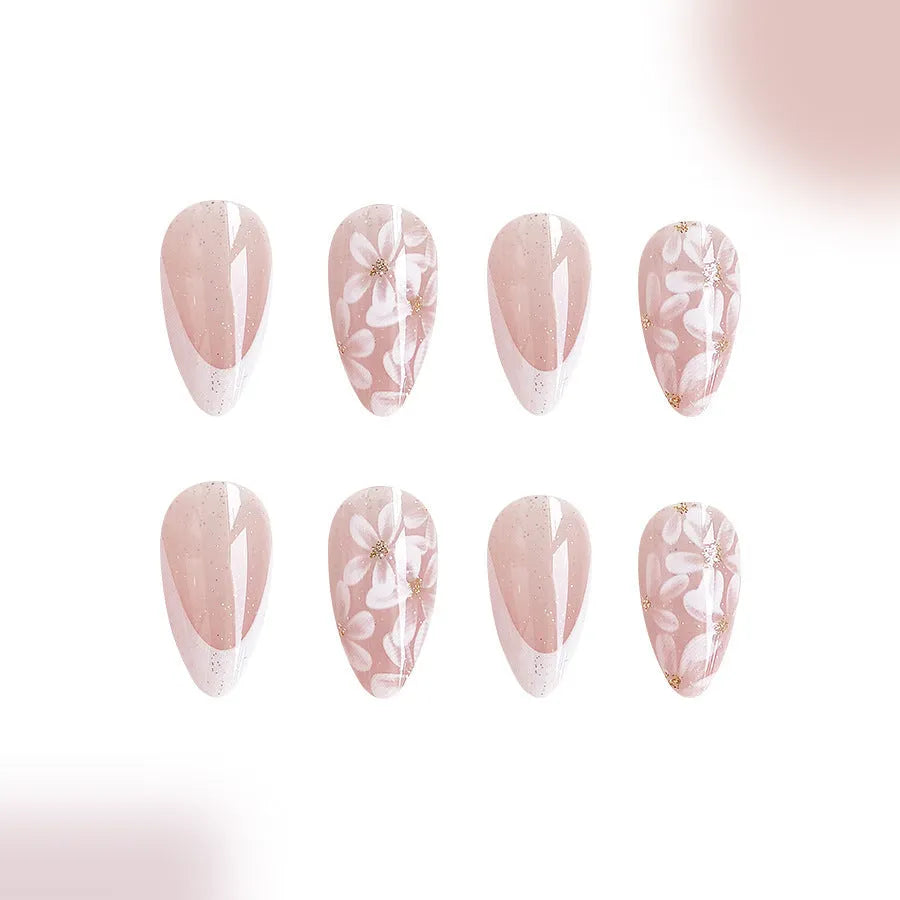 Short almond-shaped false nails with French style glitter and flower designs in colour C625