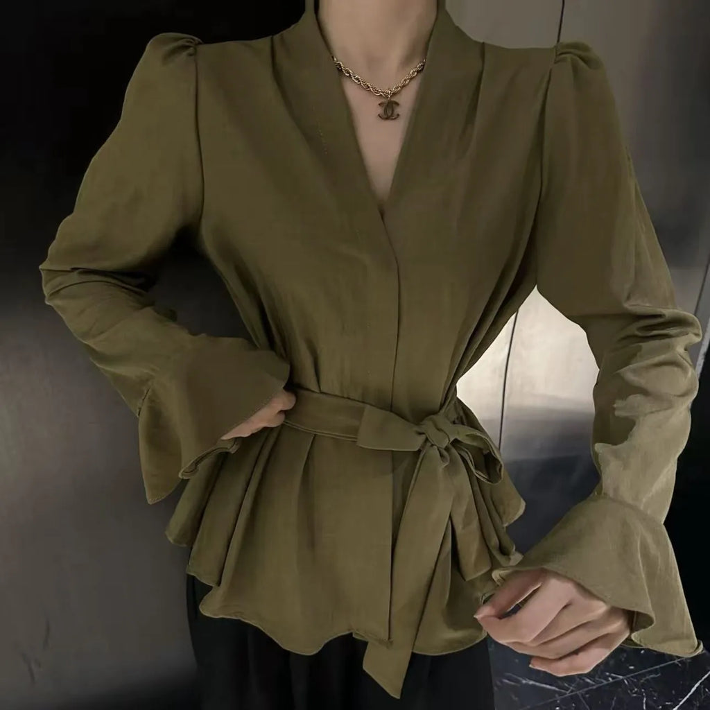 Women's black French-style shirt with long bell sleeves, an irregular collar, and a tied front detail.