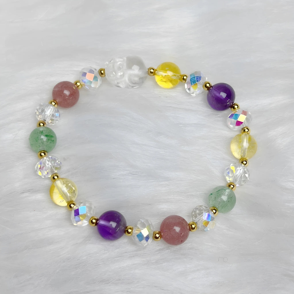 Close-up of a women's crystal bracelet with a detailed nine-tailed fox charm and colour faceted stones.