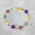 Close-up of a women's crystal bracelet with a detailed nine-tailed fox charm and colour faceted stones.
