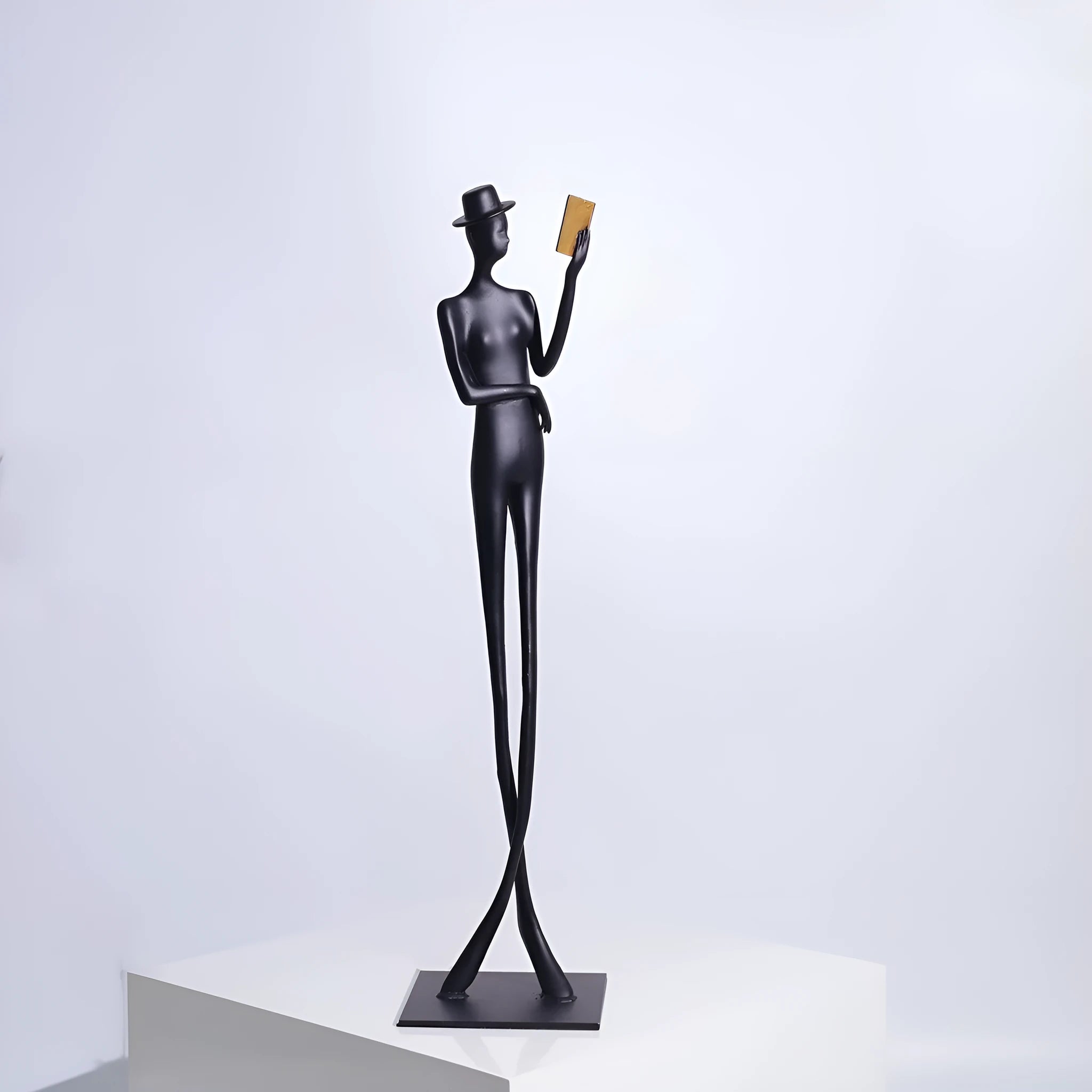 Black cast aluminium desktop sculpture of reading woman measuring 51 cm tall