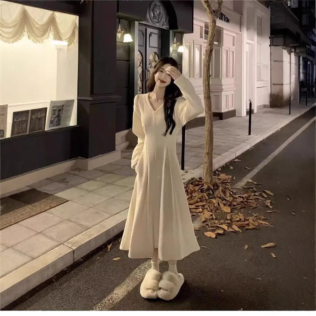 Women's knitted V-neck dress with princess sleeves and long skirt in Milky White or Black.