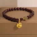 Women's Cat's Paw garnet style crystal bracelet on packaging