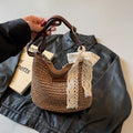 Women's woven straw shoulder messenger bag in khaki with zip pocket and single strap.