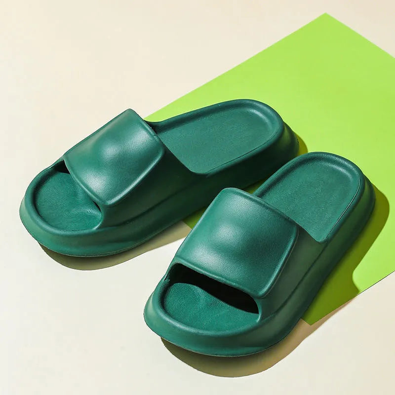 Pair of thick-soled EVA flip-flop slippers in a chosen colour on a bathroom floor.