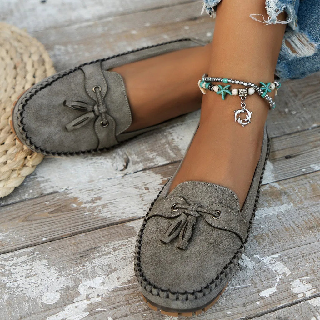 Women's suede flat shoes with a bow in pink, apricot, grey, or blue on a low polyurethane sole.