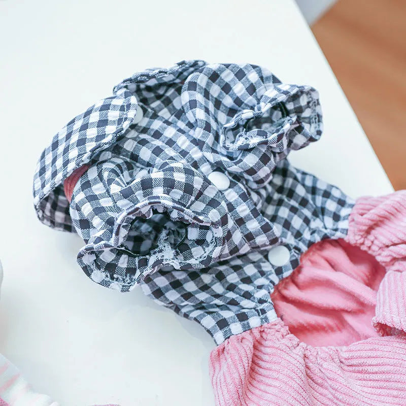 Four-legged plaid polyester pet overalls in black grid top, with full leg coverage, on a light background