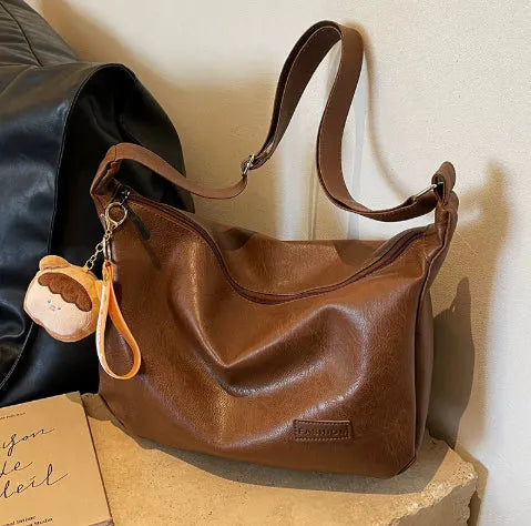 Retro PU shoulder messenger bag in dumpling shape with open pocket and sewing thread detail, black brown coffee options.