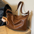 Retro PU shoulder messenger bag in dumpling shape with open pocket and sewing thread detail, black brown coffee options.