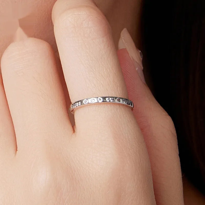 Moss Password I Love You silver-toned ring with oxidised black finish on a hand