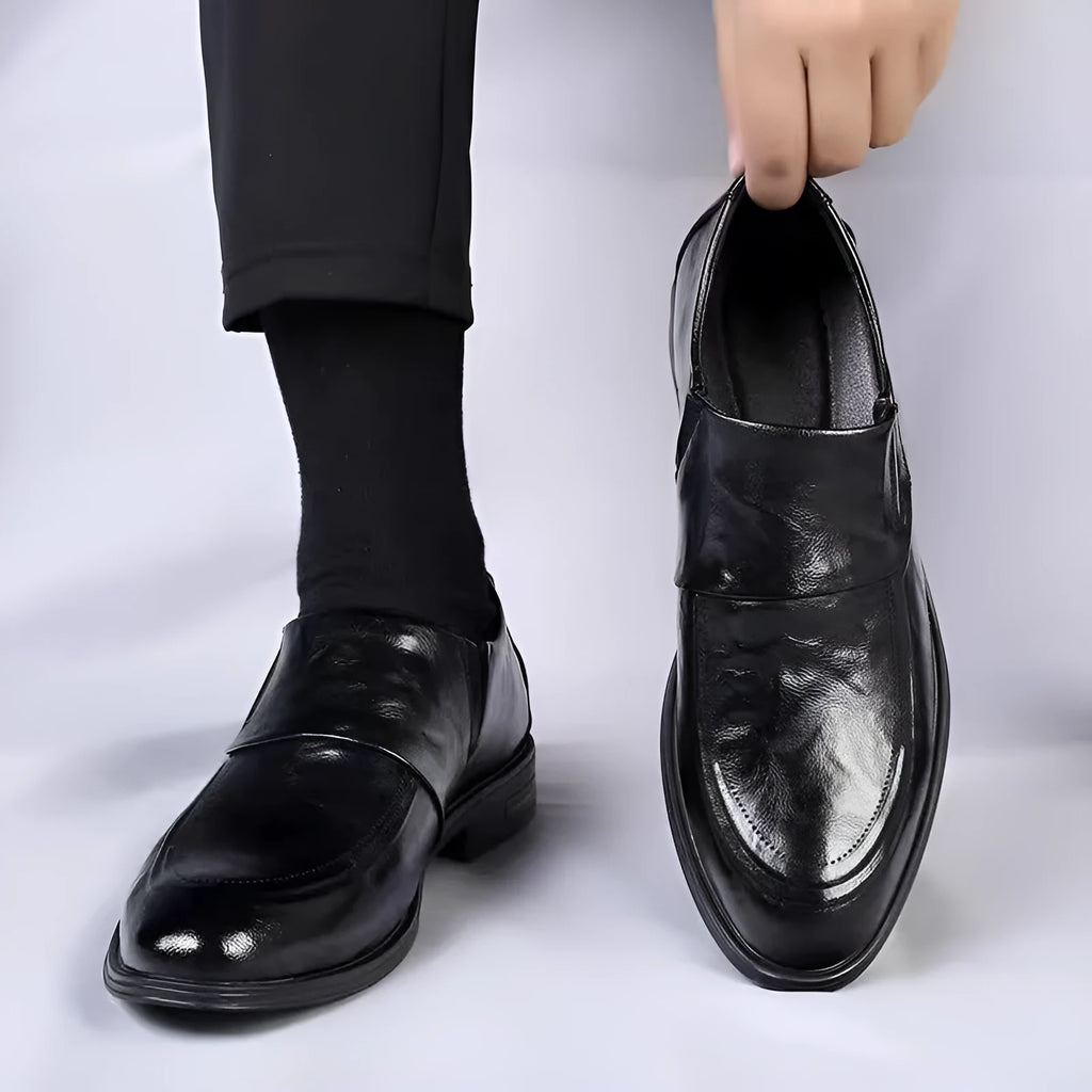 Men's black cowhide leather slip-on casual shoes with rubber sole on a plain background