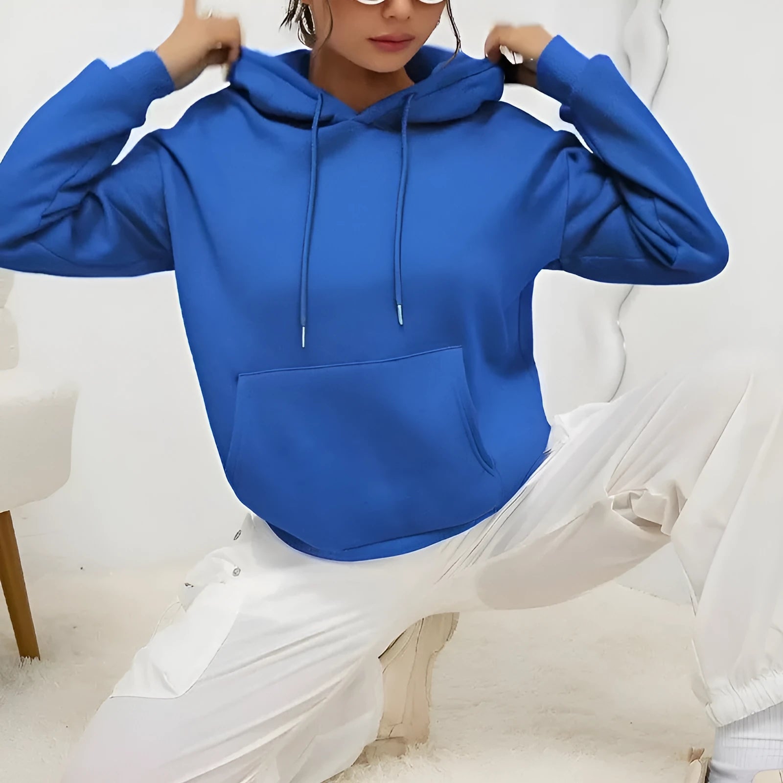 Women's loose grey drawstring hoodie with front pocket, laid flat.