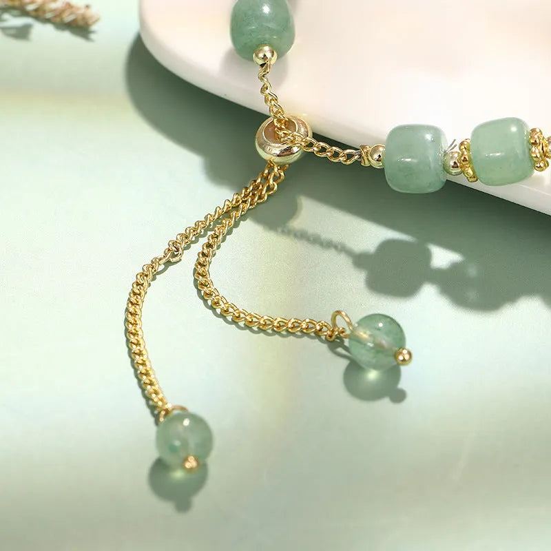 Women's rabbit design bracelet with green natural stones and copper gold accents