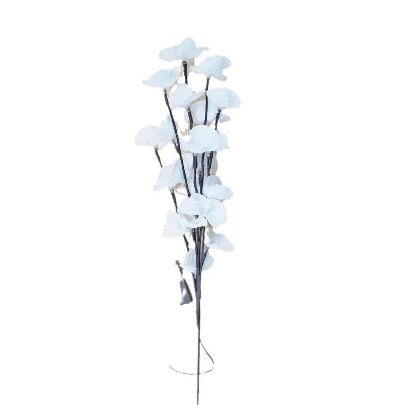 Pink LED phalaenopsis orchid branch decorative light on a table.