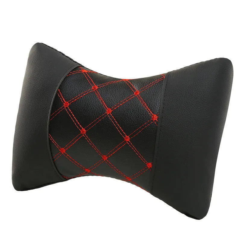 Black quilted artificial leather car headrest pillow with diamond stitching, shown on a car seat.