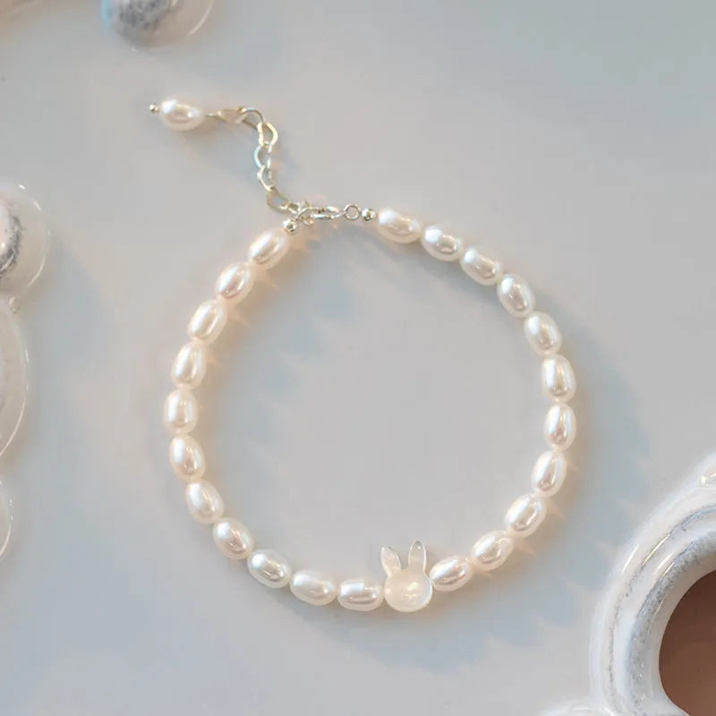 White pearl bead bracelet with 925 silver rabbit charm on elastic string