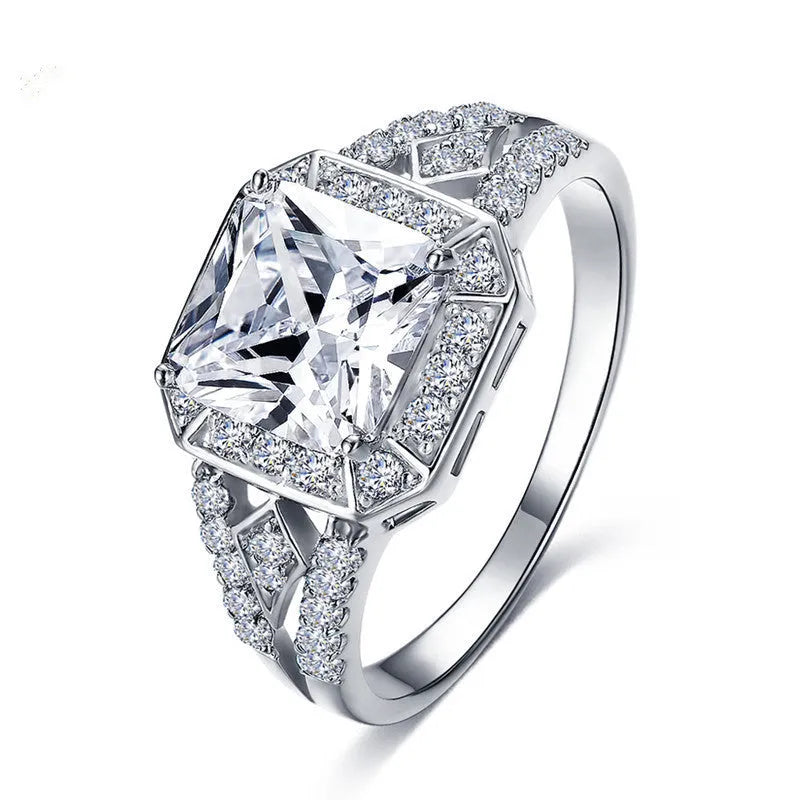 Geometric hollow design women's zircon ring in platinum finish on copper, showing quadrilateral stone.