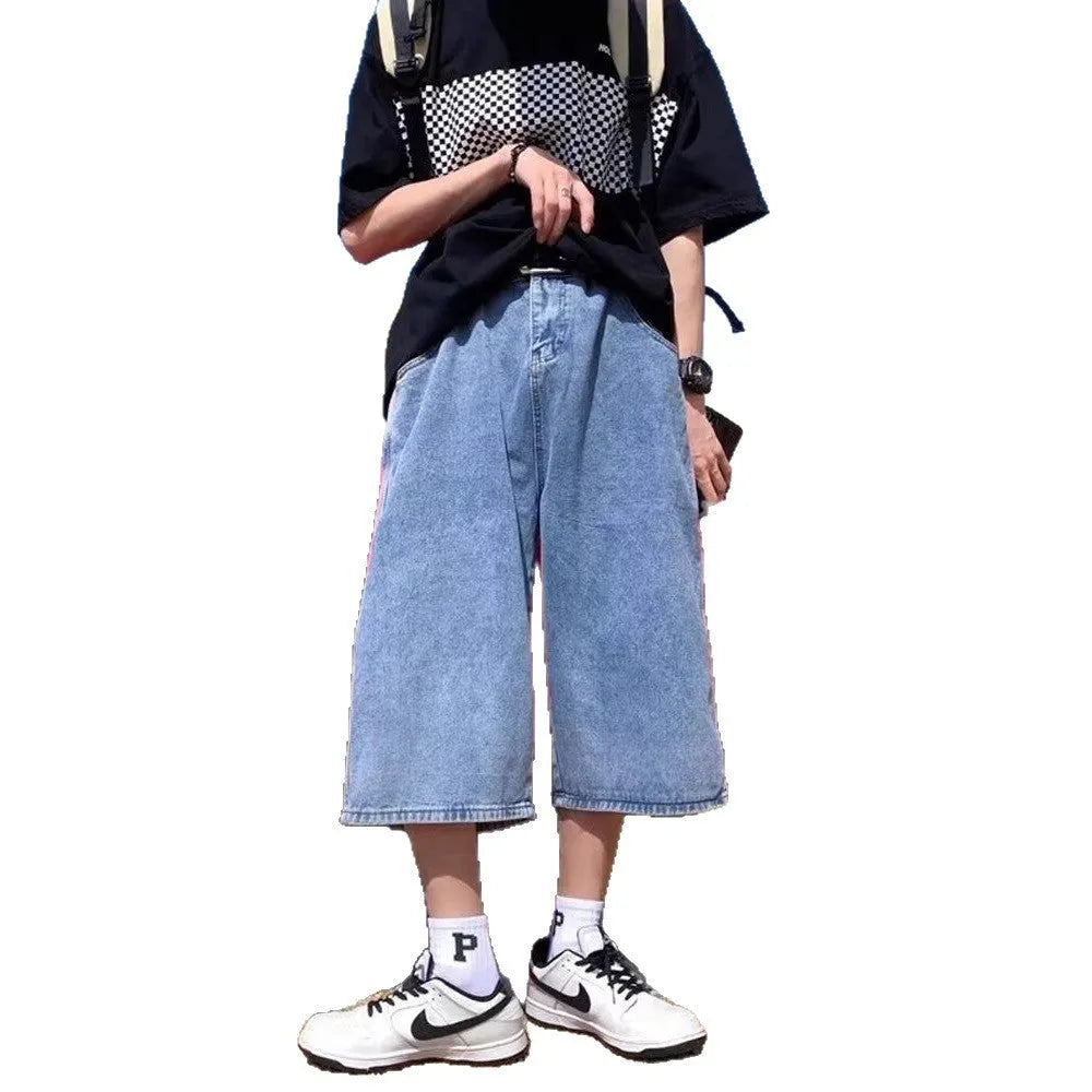 Men's blue washed denim cropped shorts with a high waist and zipper fly on a neutral background