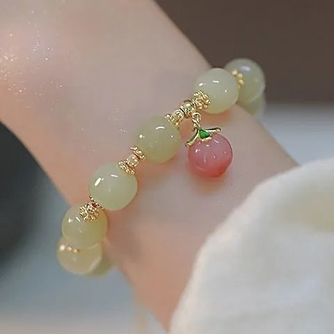 Peace buckle bracelet with a coloured glass rabbit charm on a simple band