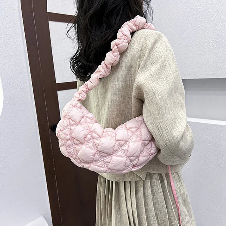 Women's nylon messenger bag in solid colour with adjustable shoulder strap, shown in beige