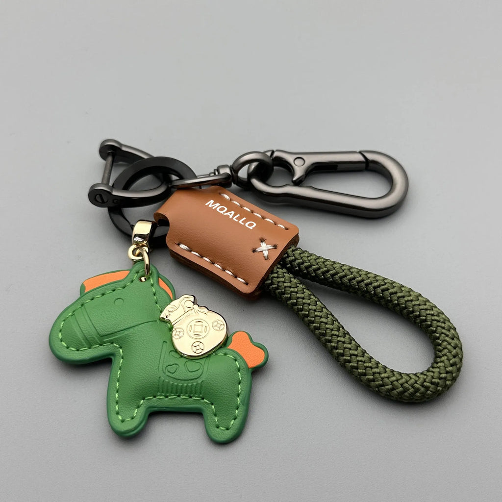 Handmade brown cowhide leather keychain with a zinc alloy pony belt buckle on a green flanelle rope.