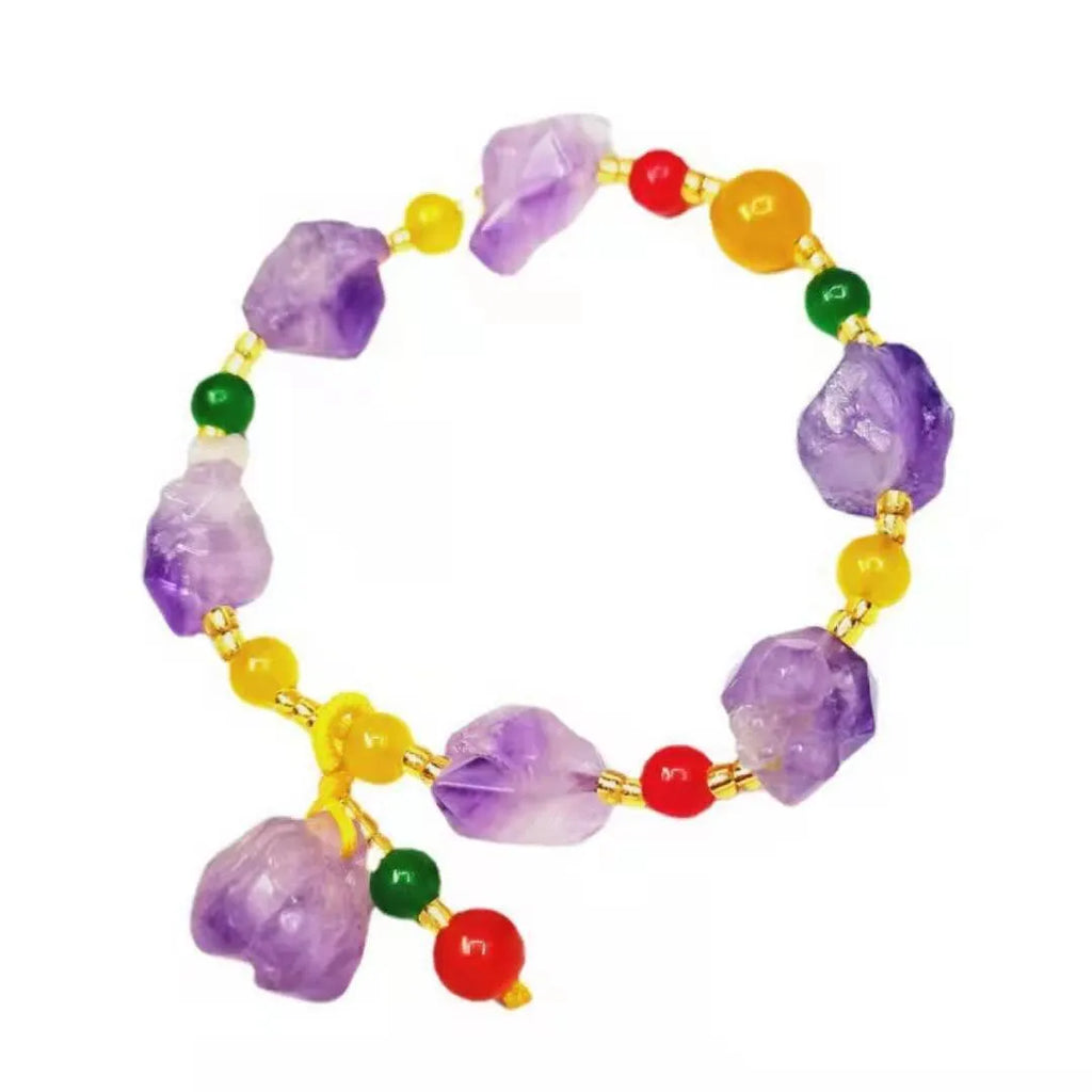 Women's amethyst bead bracelet with a Chinese fu character charm on a white background.
