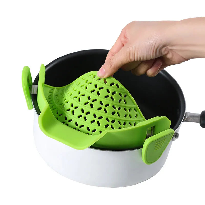 Silicone and stainless steel pot side drain stopper in multiple colours on a kitchen counter.