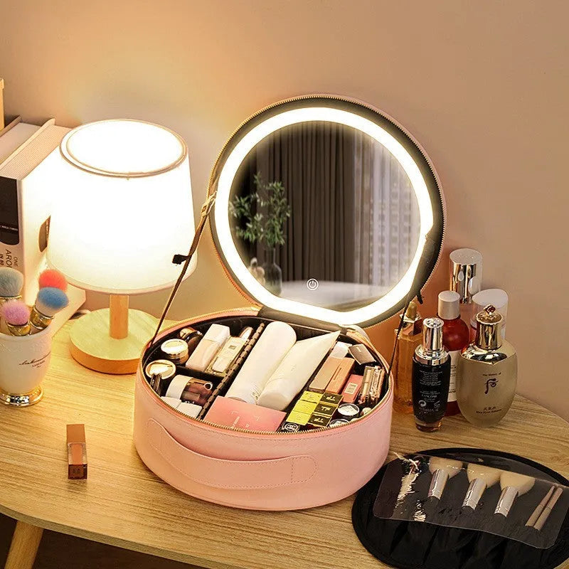 Round pink PU leather makeup bag with built-in LED illuminated mirror and internal cosmetic partitions open.