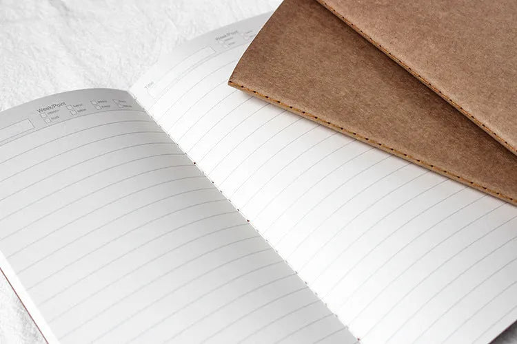 11x21cm cowhide diary refill notebook with saddle stitch binding and ivory white paper pages.