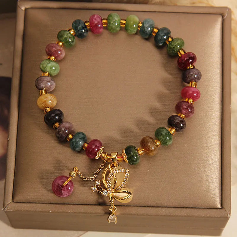 Colourful women's bracelet with butterfly charm and bead accents on alloy band