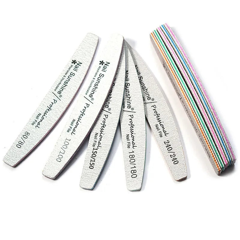 Grey half-moon shaped nail file with washable grit surface on a plain background.