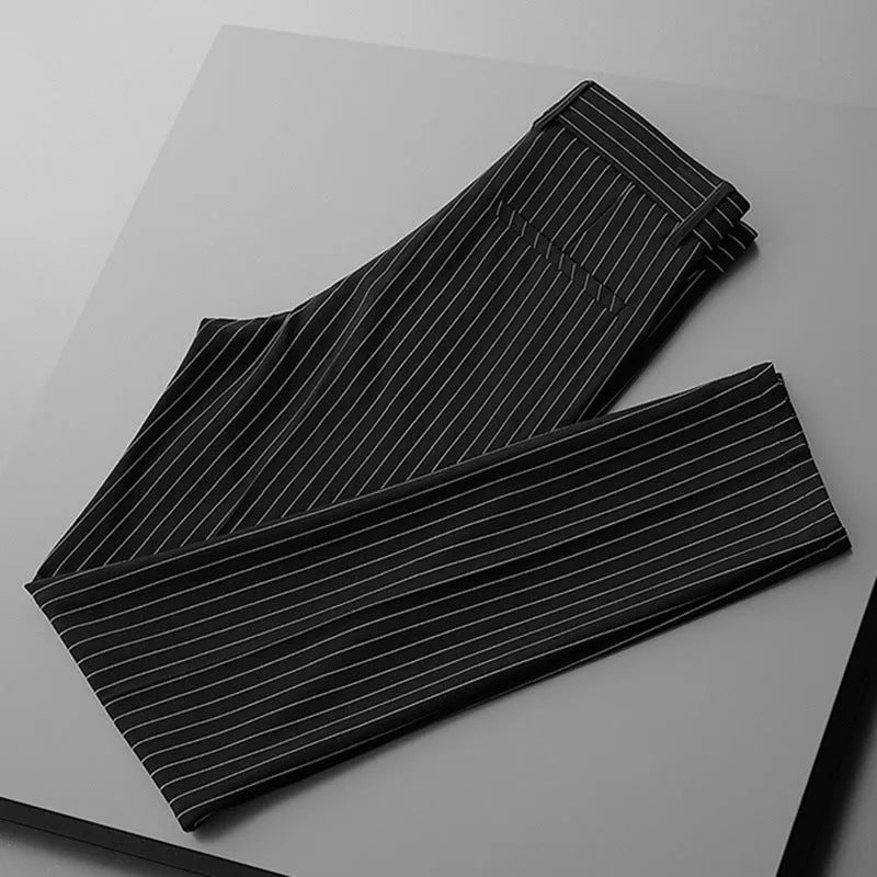 Men's loose draping suit pants in thin striped fabric showing trousers style and crop jeans cuts in black and white colours