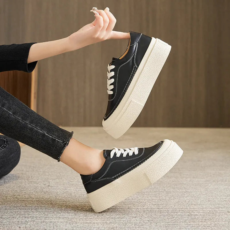 Women's black embossed cowhide platform sports board shoes with a rubber sole.