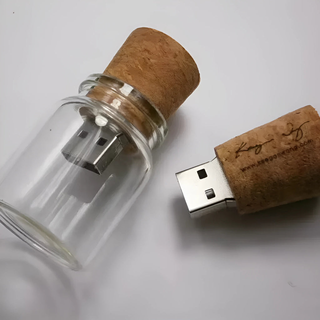 Wooden-lidded transparent glass bottle-shaped USB flash drive on a white background.