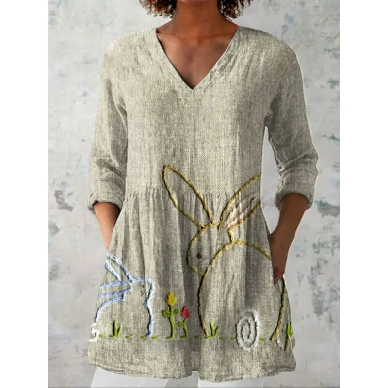 Women's loose-fit dress with blue and white wave pattern print and three-quarter length sleeves.