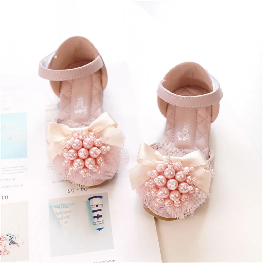 Girls princess peep toe sandals with pearl flower decoration in beige colour on display